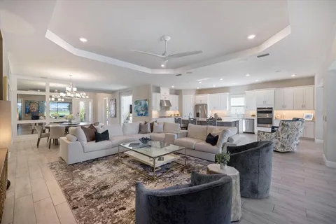 a living room with furniture a large window and a fireplace