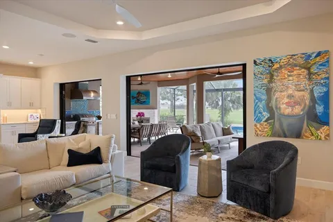 a view of a dining room with furniture wooden floor and painting on the wall