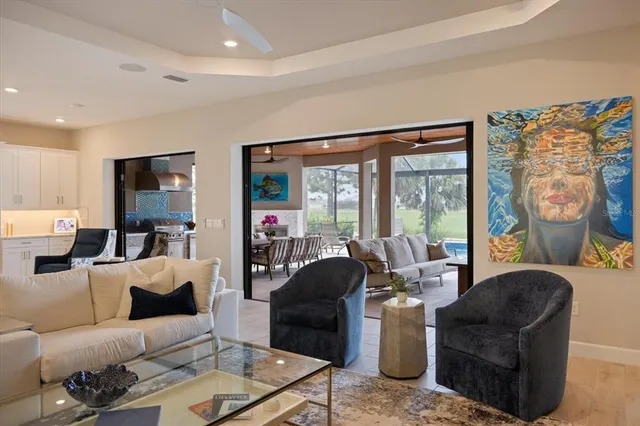 a view of a dining room with furniture wooden floor and painting on the wall