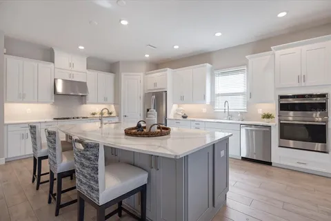 a living room with patio furniture and a floor to ceiling window