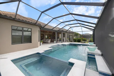 a bedroom with a bed a mirror and a large window
