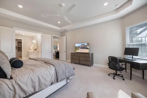 a front view of a house with a yard and potted plants