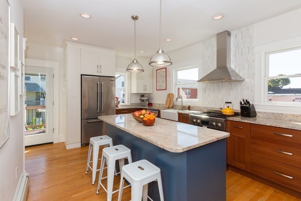 a kitchen with stainless steel appliances granite countertop a sink refrigerator and cabinets