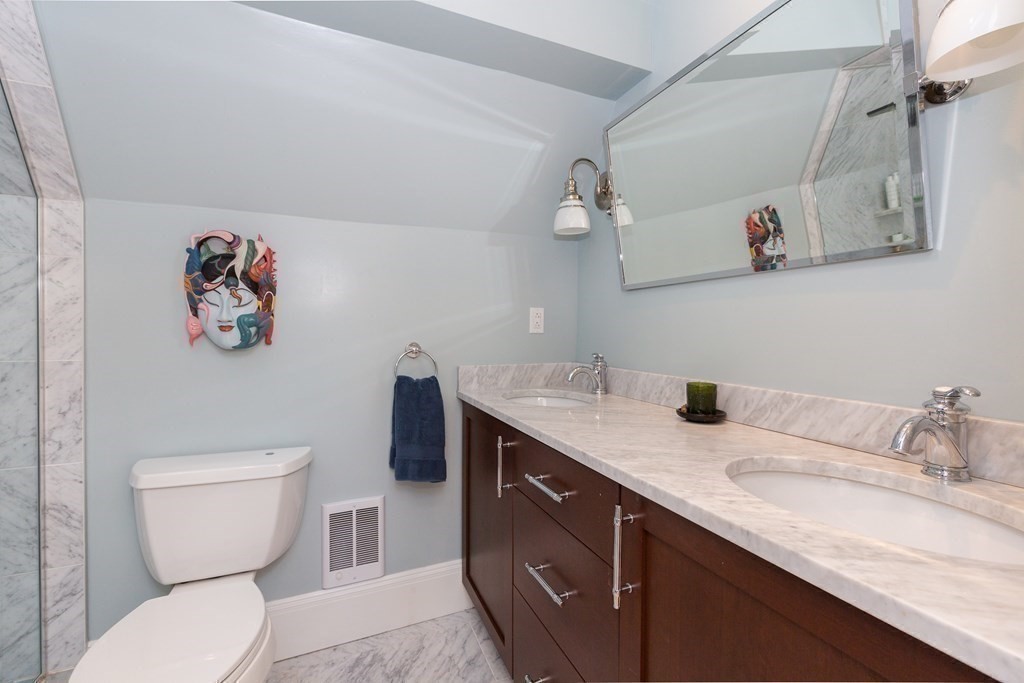 9 Trowbridge Street Arlington, MA 02474 - Photo 11 of 22 a bathroom with a granite countertop sink mirror vanity and toilet