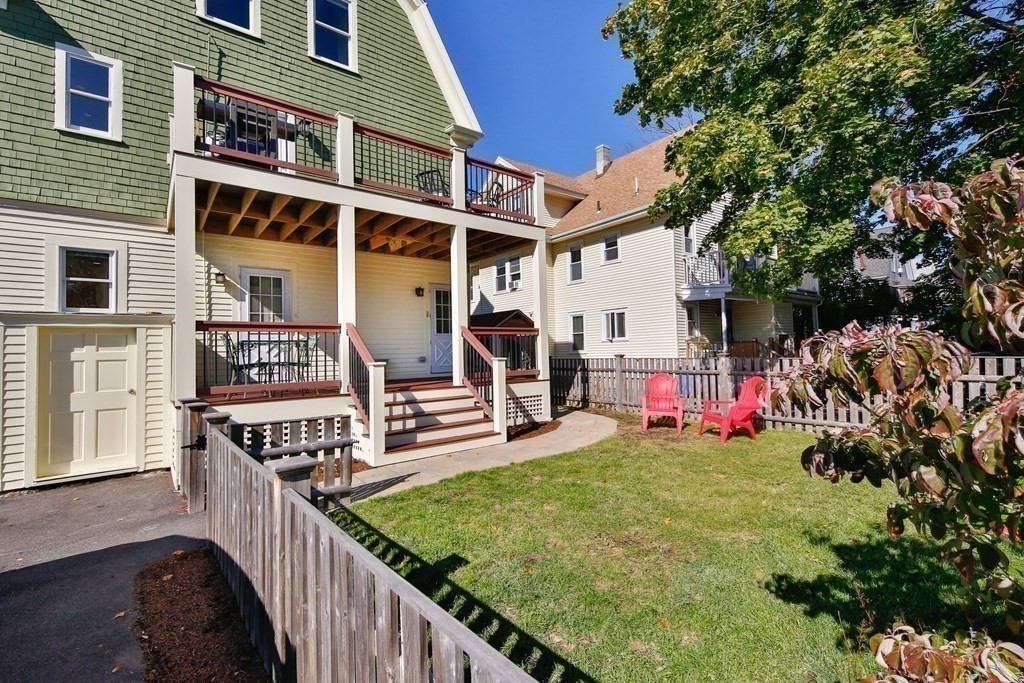 9 Trowbridge Street Arlington, MA 02474 - Photo 12 of 22 a view of a house with large tree and wooden fence