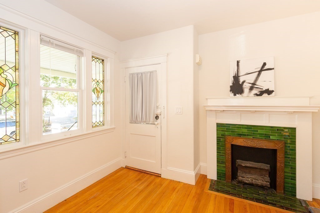 9 Trowbridge Street Arlington, MA 02474 - Photo 13 of 22 a living room with a fireplace and windows