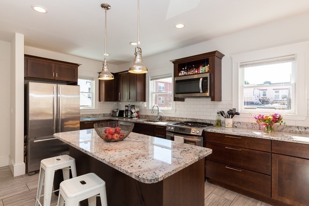 9 Trowbridge Street Arlington, MA 02474 - Photo 16 of 22 a kitchen with granite countertop a sink cabinets and stainless steel appliances