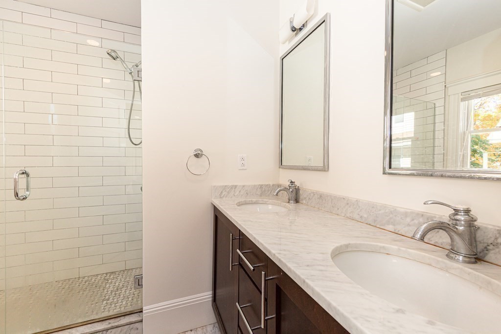 9 Trowbridge Street Arlington, MA 02474 - Photo 20 of 22 a bathroom with a granite countertop sink and a mirror
