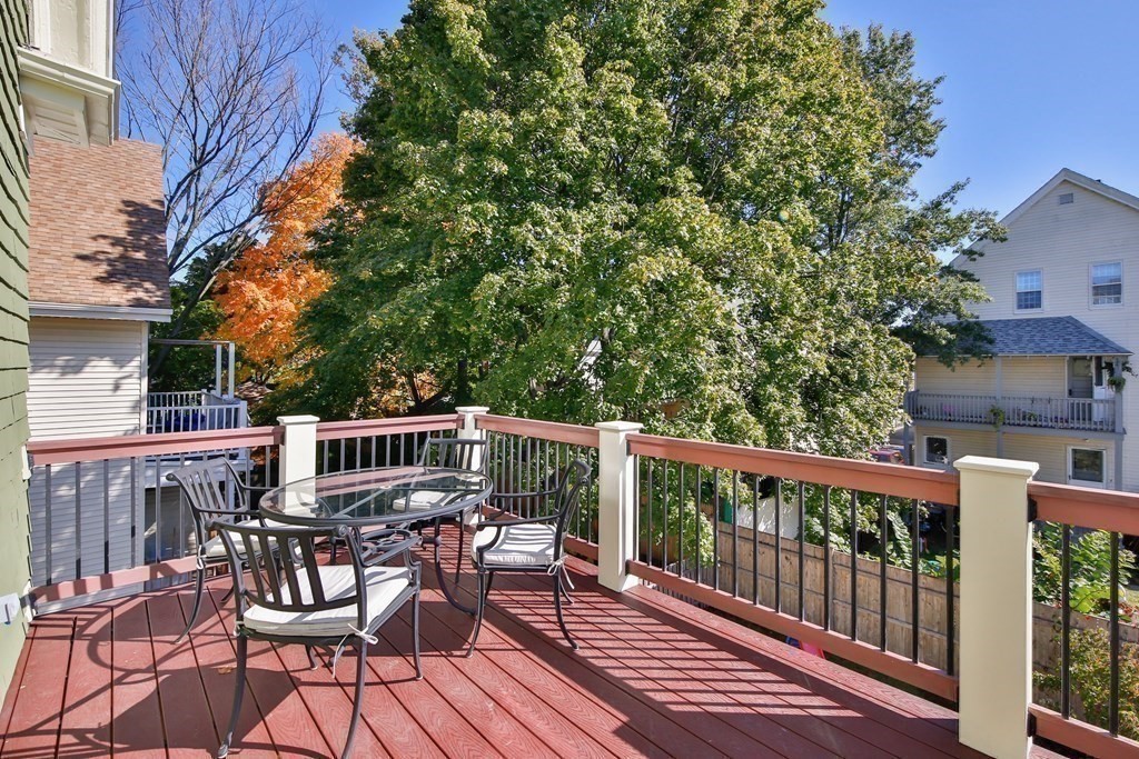9 Trowbridge Street Arlington, MA 02474 - Photo 6 of 22 a view of balcony with furniture and trees