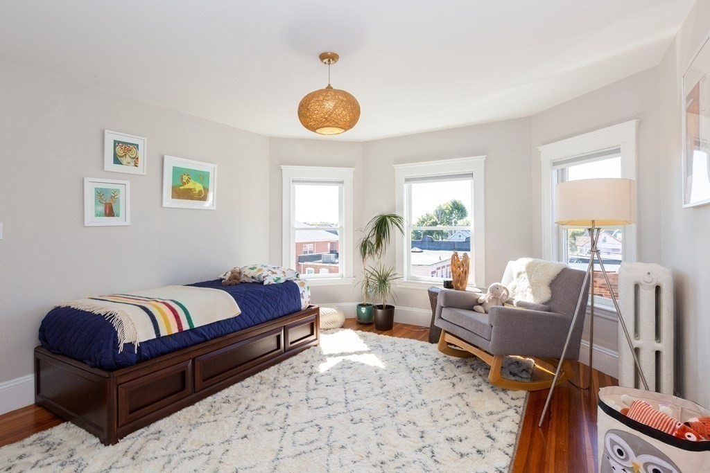 9 Trowbridge Street Arlington, MA 02474 - Photo 9 of 22 a spacious bedroom with a bed and wooden floor