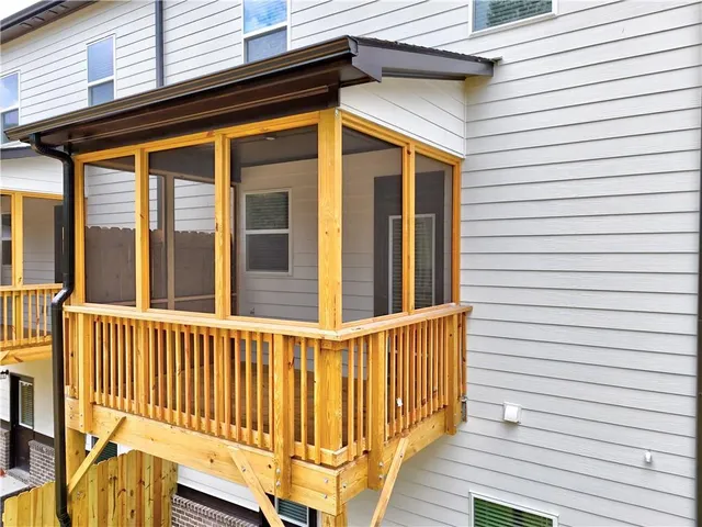 a view of a house with wooden deck