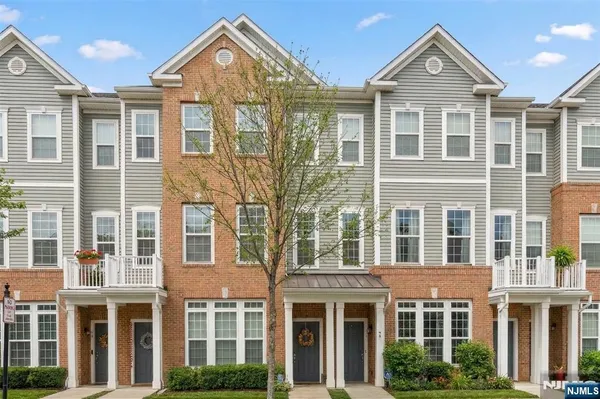 a view of a brick house with large windows