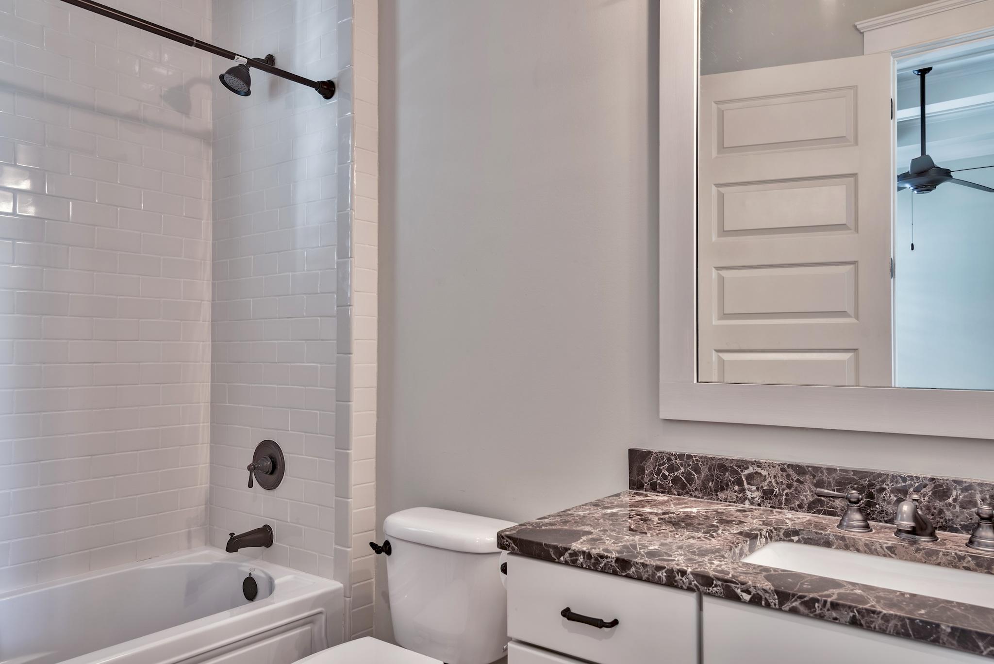 70 Pleasant Street Inlet Beach, FL 32461 - Photo 14 of 38 a bathroom with a granite countertop sink toilet and shower