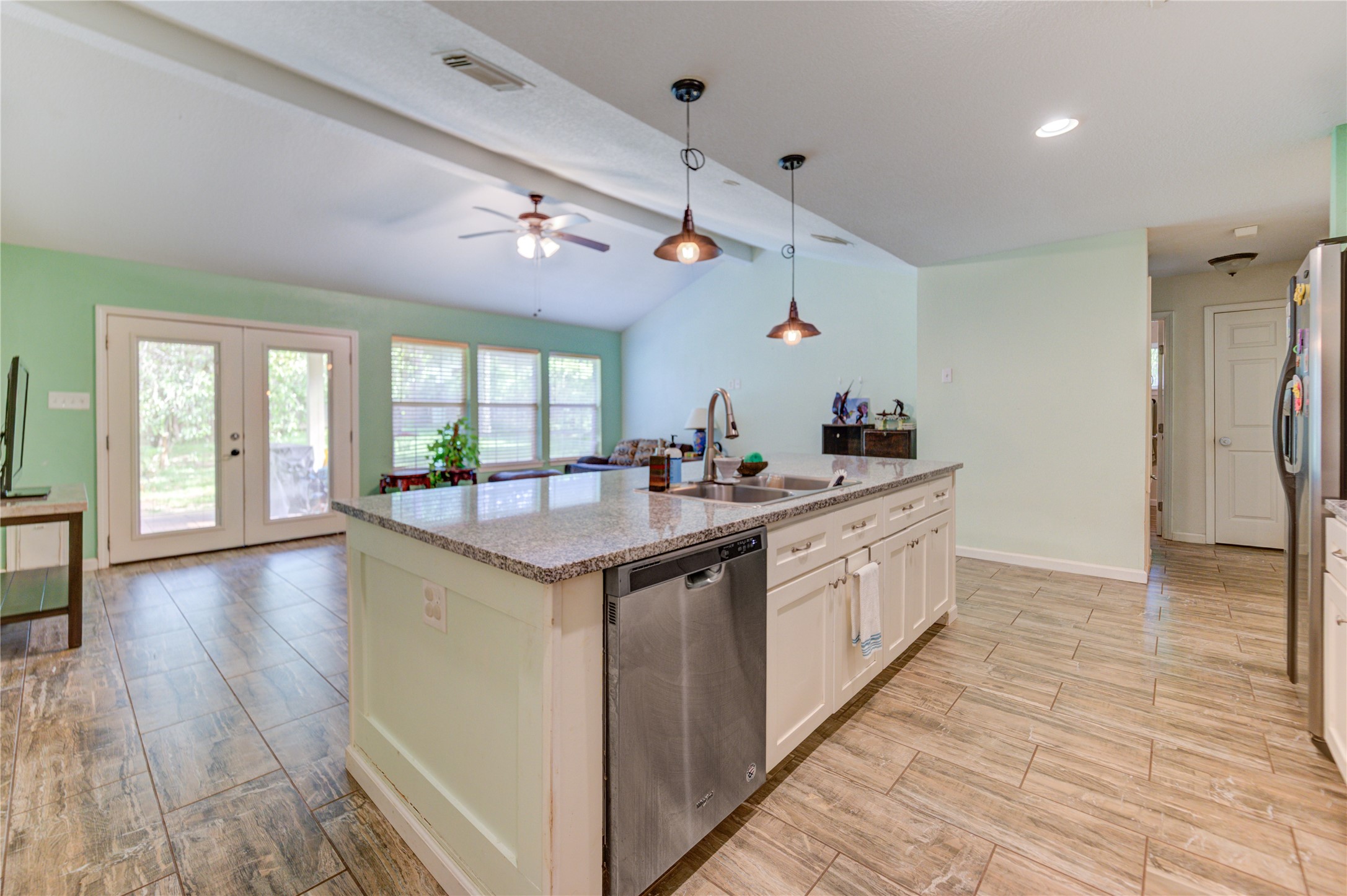 3530 Kentwood Drive Spring, TX 77380 - Photo 20 of 37 a large kitchen with kitchen island granite countertop a large window and stainless steel appliances