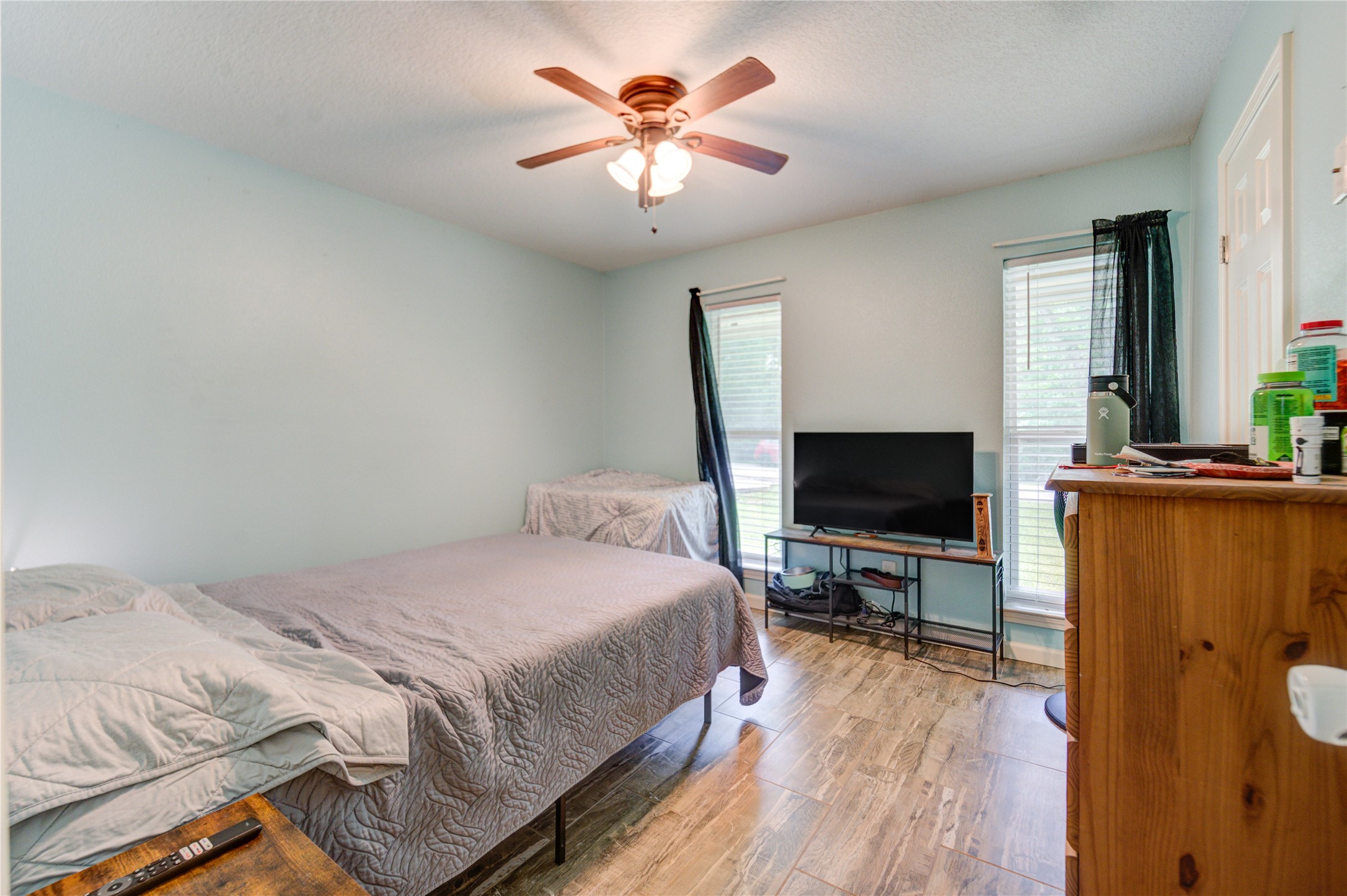 3530 Kentwood Drive Spring, TX 77380 - Photo 26 of 37 a bedroom with bed tv and wooden floor