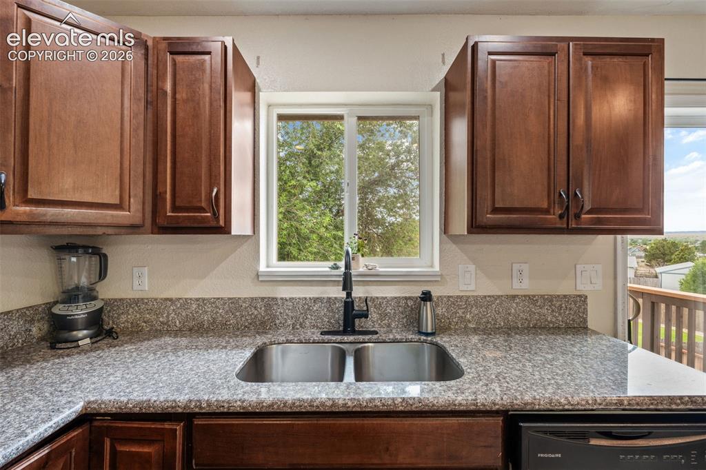 125 Diamond E Road Fountain, CO 80817 - Photo 14 of 43 a kitchen with granite countertop a sink and a window