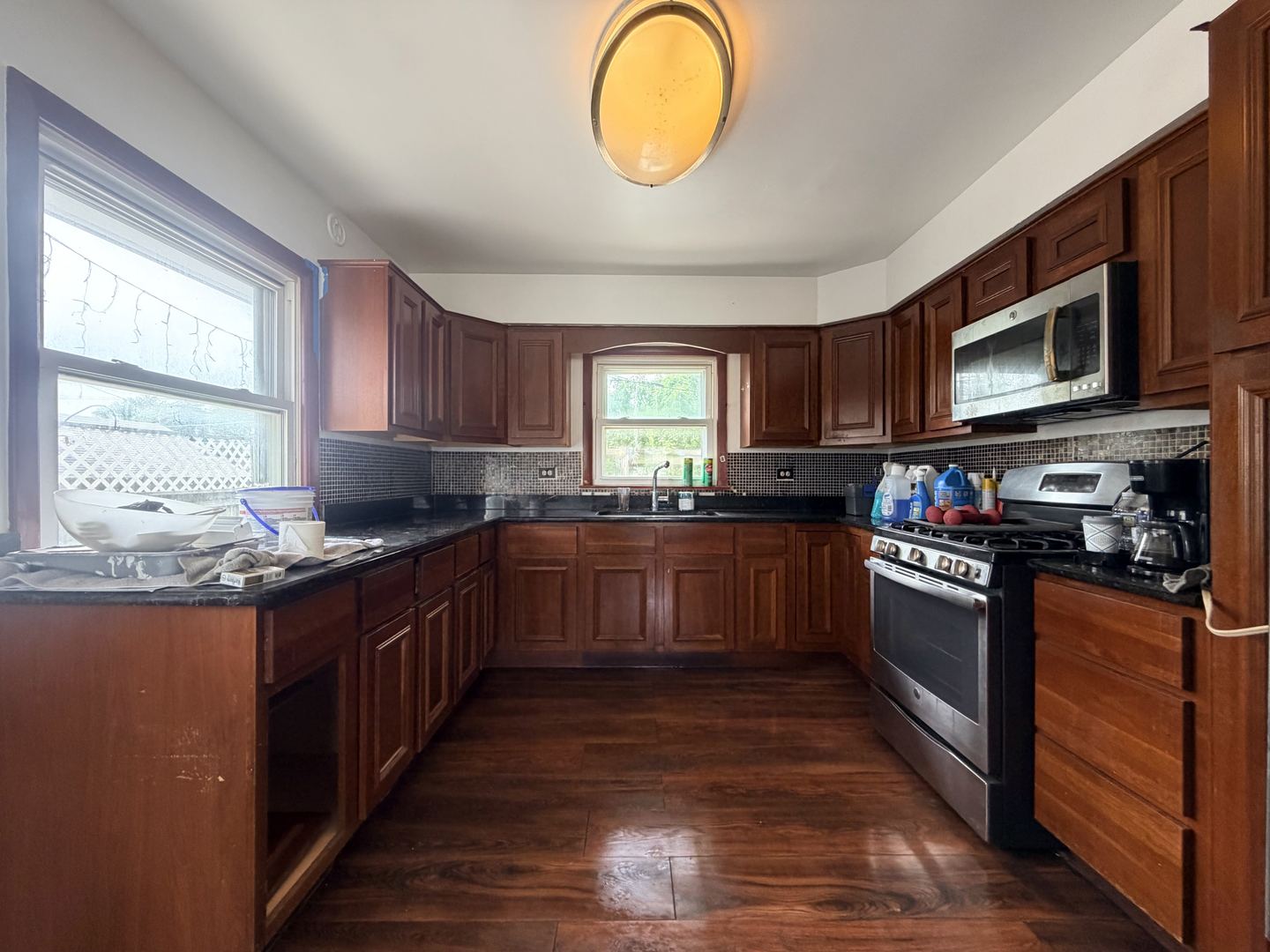 128 North York Road Bensenville, IL 60106 - Photo 5 of 39 a kitchen with stainless steel appliances granite countertop a stove a sink dishwasher and a microwave oven with wooden cabinets