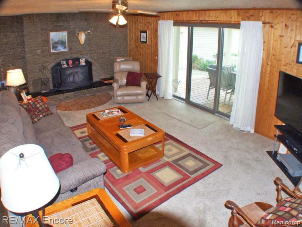 9965 Bridge Lake Road Clarkston, MI 48348 - Photo 10 of 34 Family room with natural fireplace and patio door to covered deck.