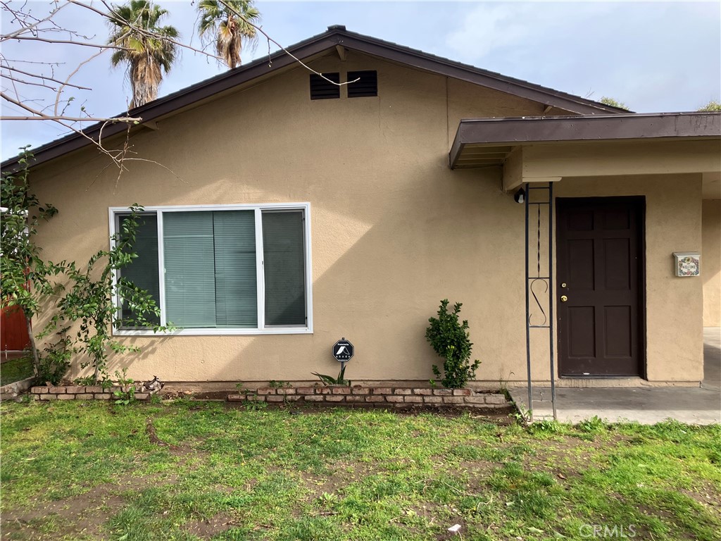 a view of the house with a yard