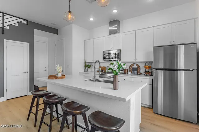 a kitchen with refrigerator and cabinets