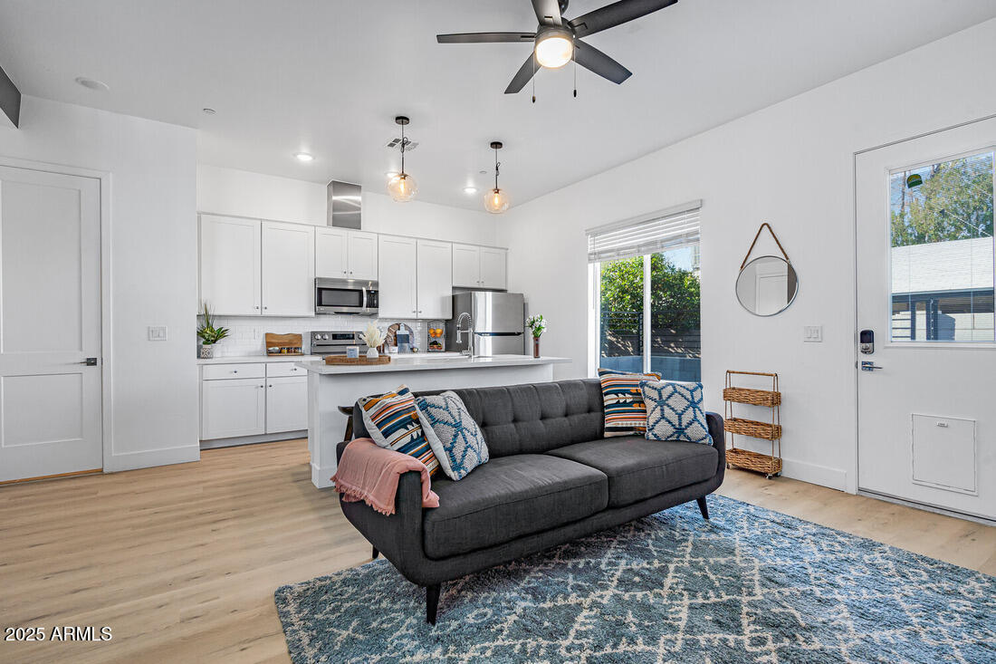 1247 East Colter Street, Unit 1 Phoenix, AZ 85014 - Photo 11 of 32 a living room with furniture and kitchen view