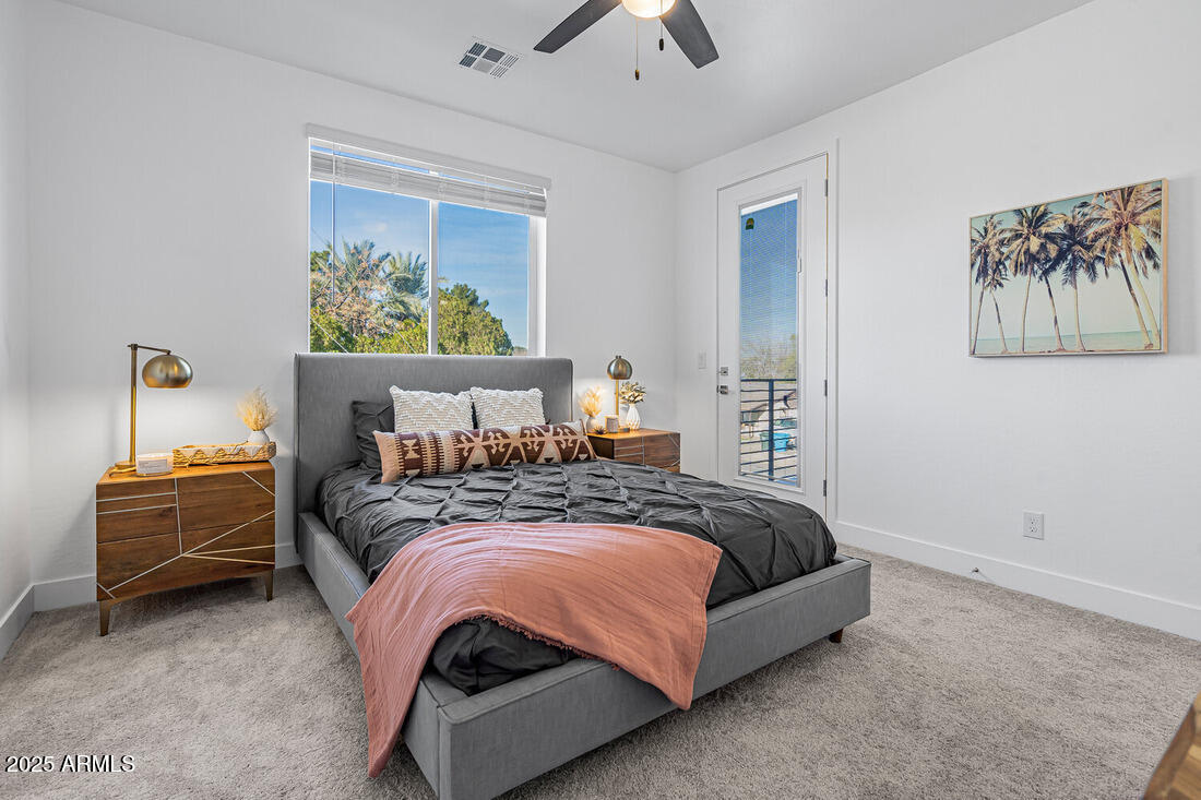 1247 East Colter Street, Unit 1 Phoenix, AZ 85014 - Photo 12 of 32 a bed sitting in a bedroom next to a window