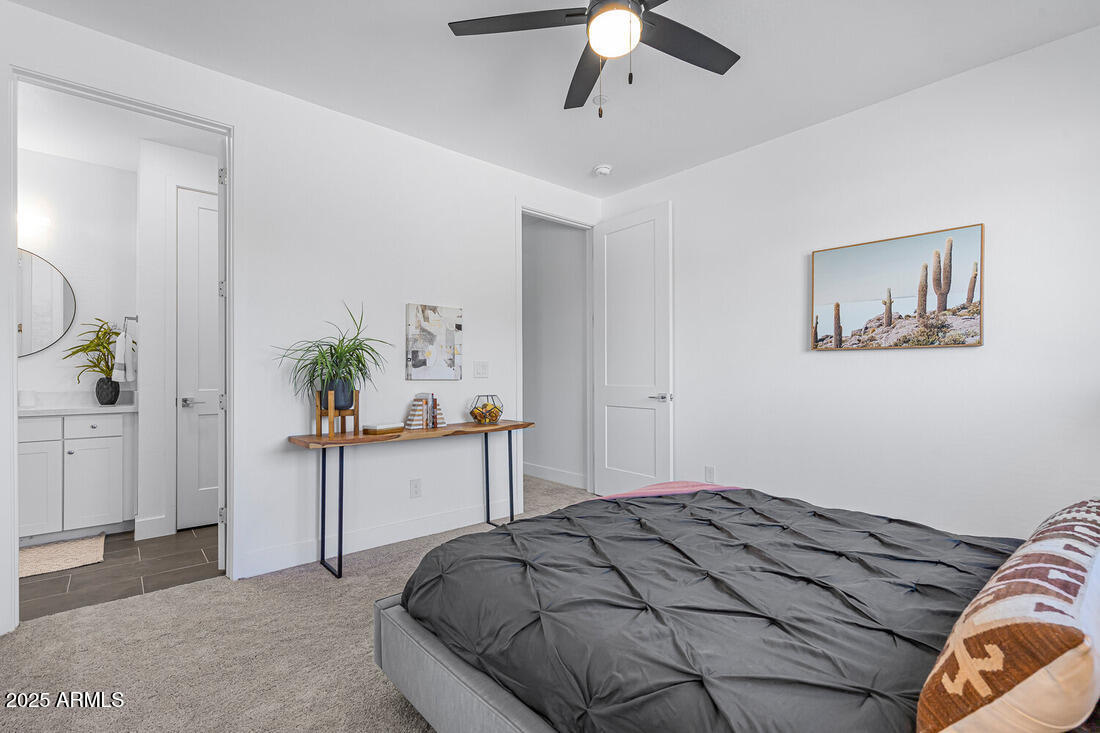 1247 East Colter Street, Unit 1 Phoenix, AZ 85014 - Photo 14 of 32 a bedroom with a bed and a chandelier