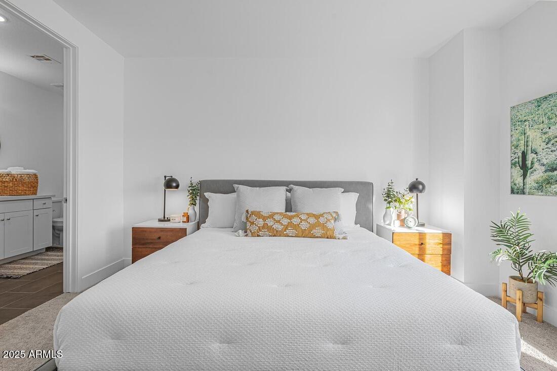 1247 East Colter Street, Unit 1 Phoenix, AZ 85014 - Photo 22 of 32 a bedroom with a bed and a potted plant