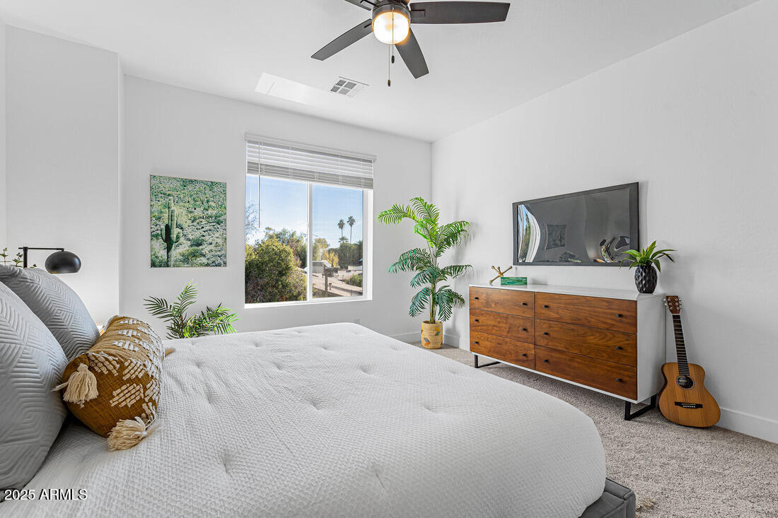1247 East Colter Street, Unit 1 Phoenix, AZ 85014 - Photo 23 of 32 a bedroom with a bed and a potted plant