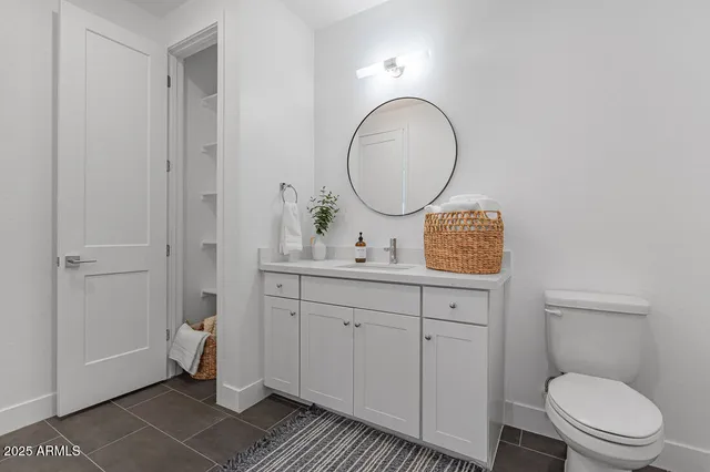 a bathroom with a toilet a sink and a mirror