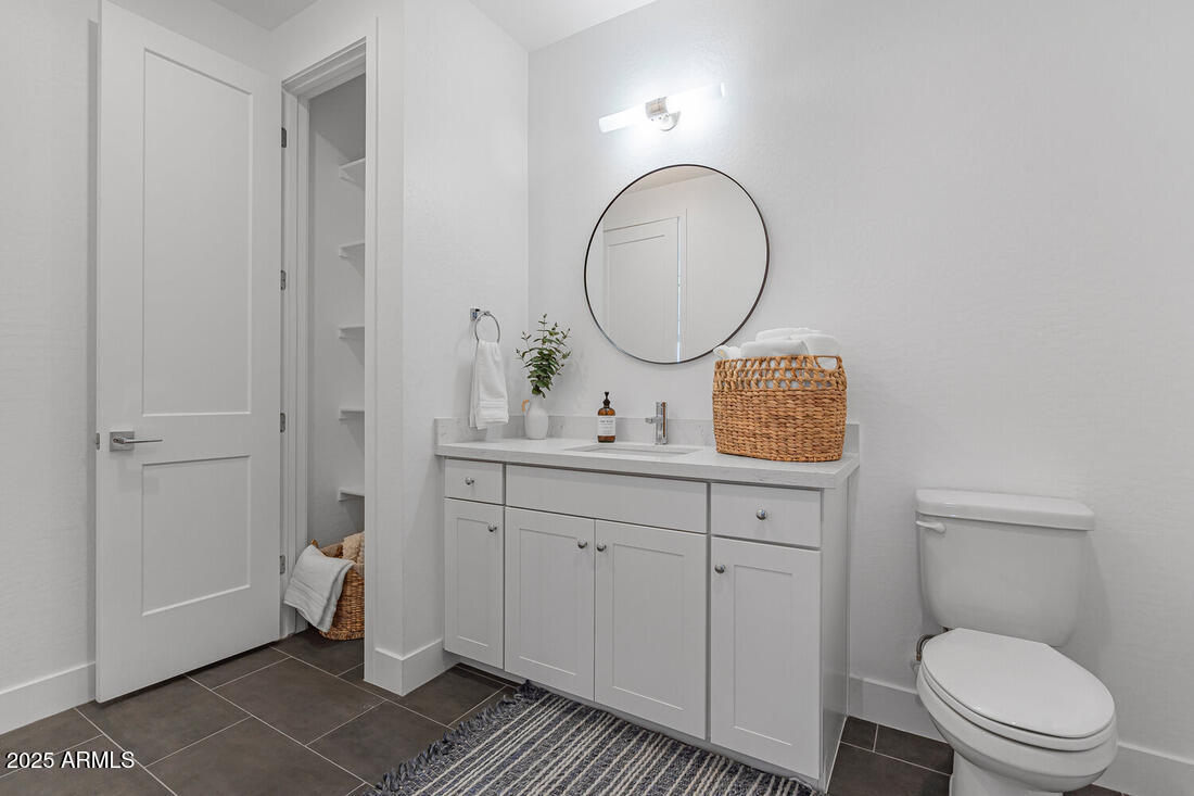 1247 East Colter Street, Unit 1 Phoenix, AZ 85014 - Photo 26 of 32 a bathroom with a toilet a sink and mirror