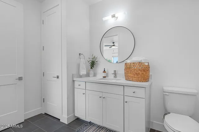 a bathroom with a toilet a sink a mirror and bathtub