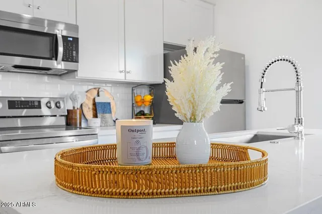 a kitchen with a sink and a mirror