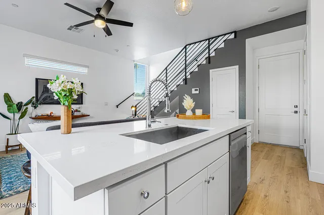 a kitchen with stainless steel appliances a sink a stove and cabinets