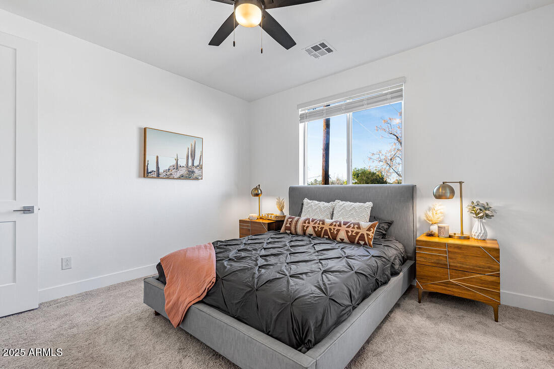1247 East Colter Street, Unit 1 Phoenix, AZ 85014 - Photo 10 of 32 a bedroom with a bed and a chandelier