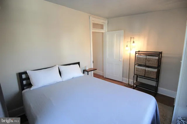 a bedroom with a bed and cabinets