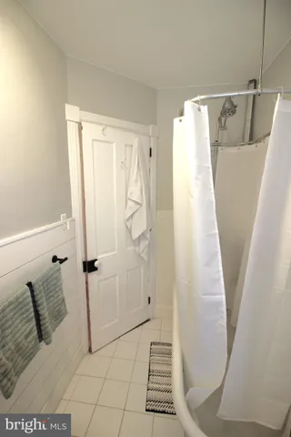 a view of a bathroom with bathtub and shower