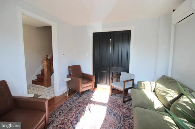 a living room with furniture and a lamp