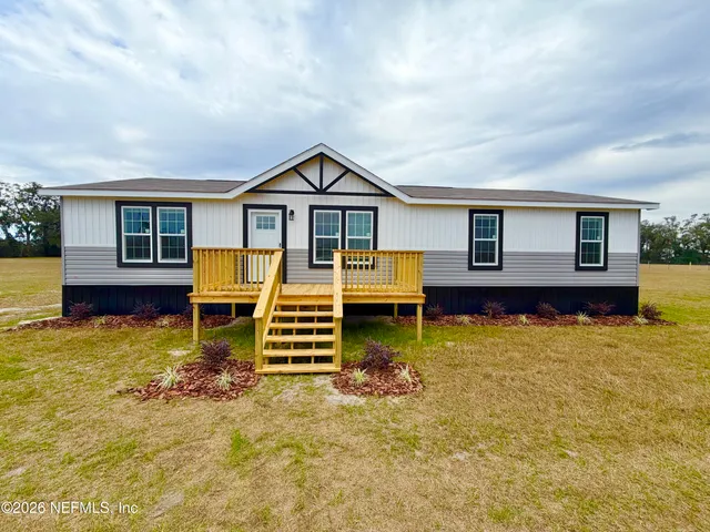 a view of a house with wooden floor and a yard