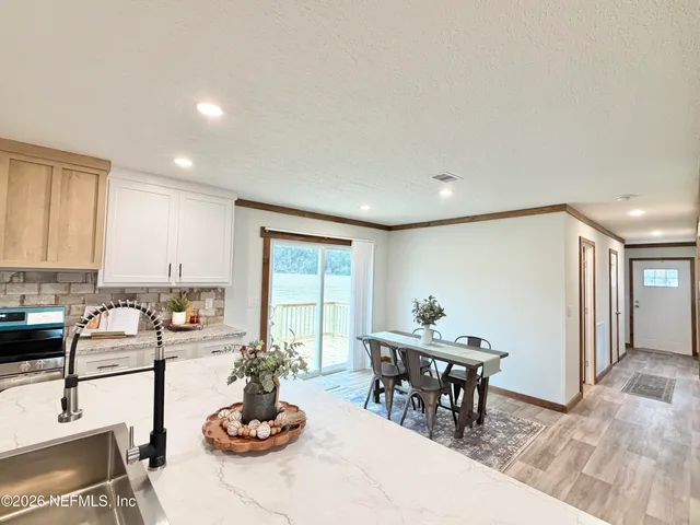 a living room with furniture a window and a table