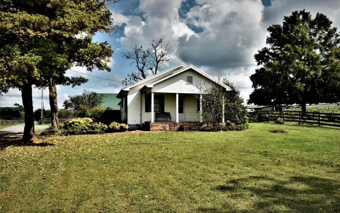 a view of a house with backyard porch and sitting area
