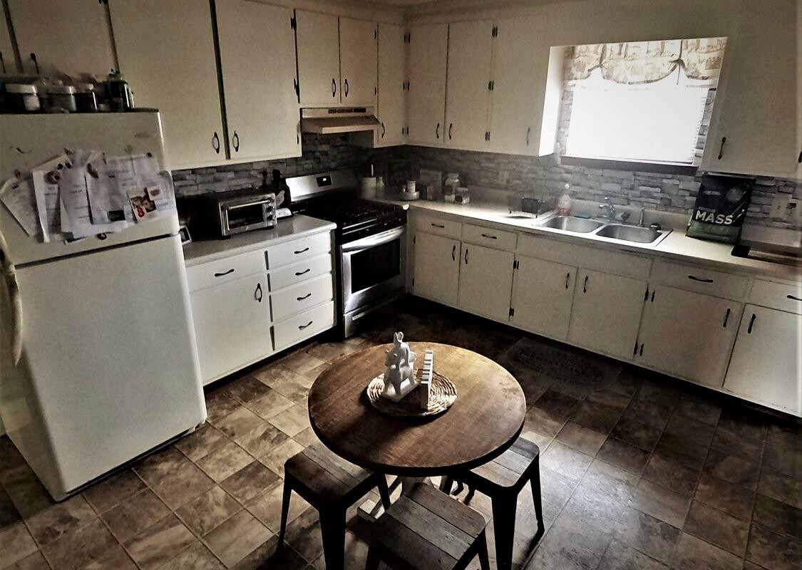 3833 Spring Place Road Southeast Cleveland, TN 37323 - Photo 4 of 8 a kitchen with appliances a sink and cabinets