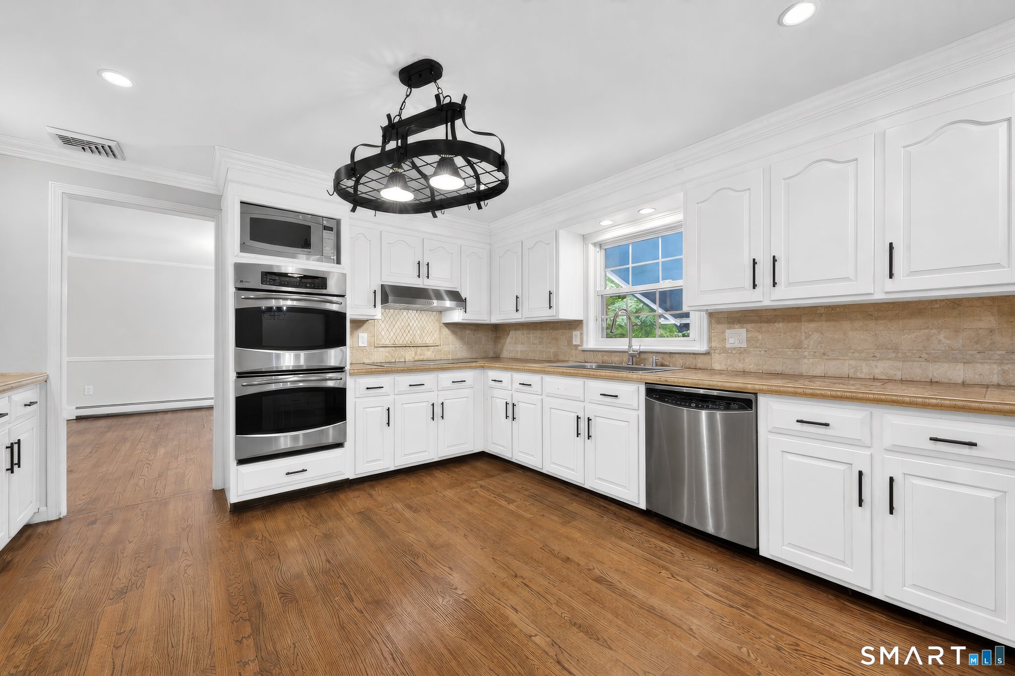 70 Barrack Hill Road Ridgefield, CT 06877 - Photo 4 of 32 a kitchen with stainless steel appliances a white cabinets and wooden floor