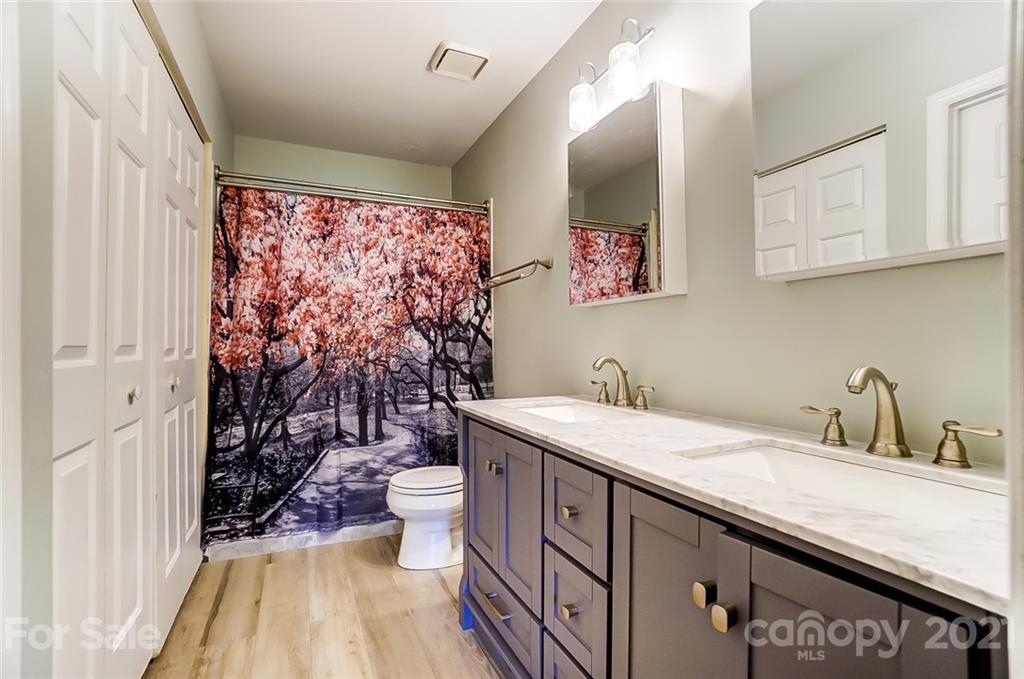8233 Golf Ridge Drive Charlotte, NC 28277 - Photo 14 of 26 a bathroom with a granite countertop sink and a mirror