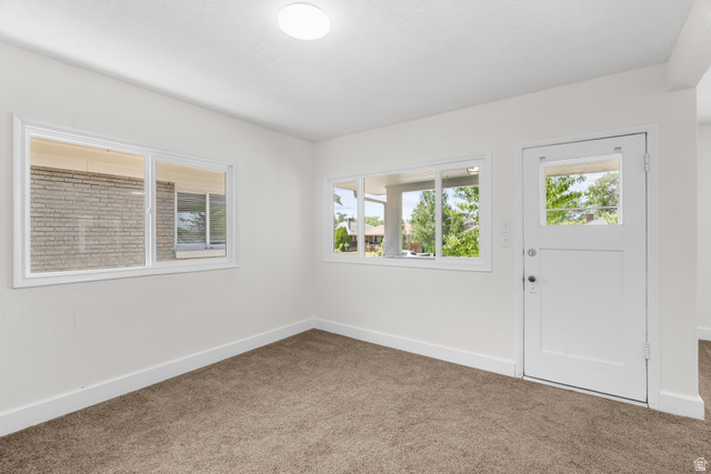 2862 Fowler Avenue Ogden, UT 84403 - Photo 9 of 23 Neutral wall color with white trim and brown carpet