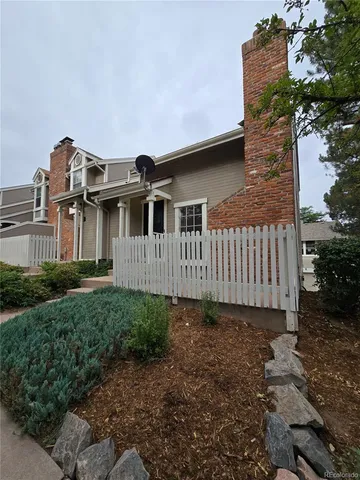 a view of a house with wooden fence