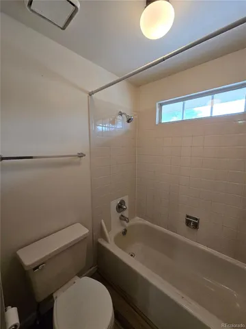 a bathroom with a toilet and a tub