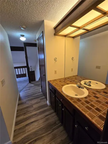 a spacious bathroom with a granite countertop sink