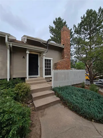 a view of a house with a yard and plants