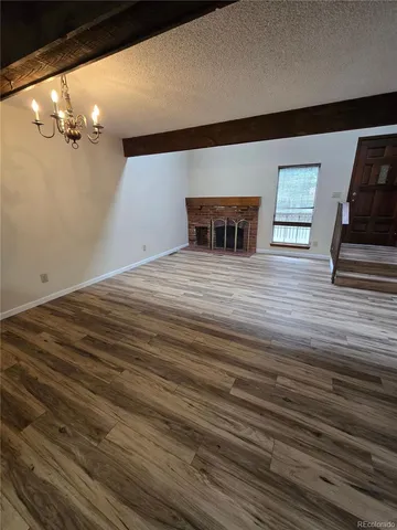 a view of a room with wooden floor and cabinet